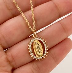 Our lady of Guadalupe necklace MATERIAL AND SIZE 18k gold plated medal 18k gold filled cable chain Cubic zirconia Size pendant: 2cmx1cm Length chain: 45cm If you have questions about the product, feel free to reach me out. Don't forget to check out my other items in the store: Https://www.etsy.com/shop/nyahwithlove Mexican Gold Necklace, Miraculous Medal Pendant Jewelry For Wedding, Miraculous Medal Wedding Pendant Jewelry, Wedding Miraculous Medal Pendant Jewelry, Spiritual Miraculous Medal Pendant Jewelry, Silver Our Lady Of Guadalupe Necklace, Spiritual Jewelry: Our Lady Of Guadalupe Round Pendant, Spiritual Virgin Mary Medallion Jewelry, Our Lady Of Guadalupe Round Pendant As Gift