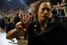 a man making the peace sign in front of an audience