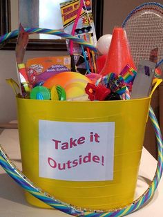 a yellow bucket filled with lots of toys