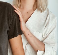 a woman with her arm around the shoulder of a man who is wearing a white shirt