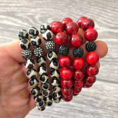 Red beads with black veining strung with black rhinestone beads on elastic cord. The bracelet measure 7 inches around. This listing is for one bracelet only.  Find our full selection of bracelets in our shop at https://www.etsy.com/shop/Immeasurablymore2 Follow Immeasurably More on Instagram immeasurablymore_) for special announcements, coupon codes, and giveaways. Cheap Red Beaded Bracelets For Festivals, Affordable Red Beaded Bracelets As Gifts, Cheap Handmade Red Stretch Bracelet, Luxury Red Handmade Beaded Bracelets, Cheap Red Beaded Bracelets, Luxury Red Beaded Bracelets With Round Beads, Stretchy Beaded Bracelet Red Instead, Red And Black Bracelets, Immeasurably More