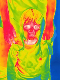 an image of a woman with her hands on her hipster's shoulder and face painted in neon colors