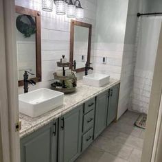 a bathroom with double sinks and two mirrors