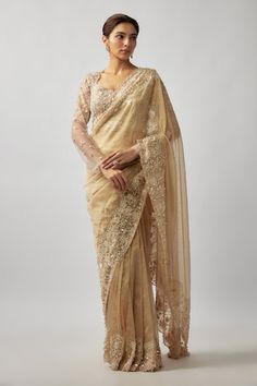 Champagne gold tulle and tissue silk saree with pearls, crystals and glass beaded hand embroidery. Comes with a padded blouse and an underskirt. - Aza Fashions Hand Embellished Pre-draped Saree For Wedding, Luxury Zari Work Dupatta For Reception, Luxury Dupatta With Zari Work For Reception, Hand Embellished Saree Blouse Piece For Wedding, Anarkali Style Gold Pre-draped Organza Saree, Hand Embellished Blouse Piece For Wedding Saree, Elegant Hand Embellished Blouse Piece For Festivals, Elegant Hand Embellished Blouse For Festivals, Luxury Tissue Silk Dupatta For Wedding