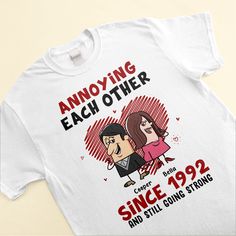 The "Annoying Each Other, Still Going Strong" Personalized Unisex T-Shirt is the perfect gift for couples who know how to embrace the fun side of their relationship. Whether it's for an anniversary, engagement, wedding, or just to celebrate your strong bond, this customizable couple shirt is a great choice. The humorous and personalized design adds a special touch, showcasing your unique connection. It's a fun way to acknowledge the ups and downs of your journey together while reaffirming your e Anniversary Crew Neck T-shirt With Custom Print, Funny T-shirt With Custom Text For Gift, Personalized T-shirt For Valentine's Day Gift, Graphic Print Top For Valentine's Day Anniversary, White Tops For Valentine's Day Anniversary, Funny Text Crew Neck Top For Anniversary, Funny Text Crew Neck T-shirt For Anniversary, Anniversary T-shirt With Funny Text, Crew Neck, Anniversary Tops With Funny Text And Short Sleeves