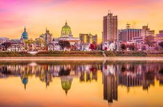 the city skyline is reflected in the water