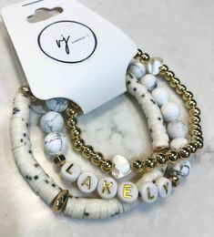 "Beautiful neutral bracelet stack with heishi beads, white howlite, and high quality gold beads. Customize made, just for you! Awesome gift for the new mom, birthday gift, or a treat for yourself.  I recommend measuring your wrist and ordering 1/2\" larger, please provide your measurement if possible. The most common size for gifting is 7\"." Casual Gold Heishi Beads Jewelry, White Stacked Stretch Bracelet As Gift, White Stacked Stretch Bracelet Gift, Custom Name White Heishi Beads Jewelry, Trendy White Stacked Beaded Bracelets, Trendy White Stacked Bracelets, Trendy White Custom Name Jewelry, White Stretch Bracelet With Stacked Round Beads, White Stacked Beaded Bracelets As Gift