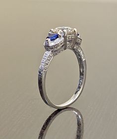 DeKara Designs Collection Beautiful Modern/Art Deco Diamond Blue Sapphire Pave Set Engagement Ring. Metal- 90% Platinum, 10% Iridium. Stones- 1 Genuine Round Diamond K-L Color VS1-VS2 Clarity 1.01 Carats, 96 Round Diamonds H-I Color SI1 Clarity 0.52 Carats, 2 Special Cut Trapezoid Blue Sapphires 0.40 Carats. Size- 6 1/2. FREE SIZING A Jaw Drop Gorgeous Art Deco Inspired Round Diamond Center Special Cut Blue Sapphire Diamond Engagement Ring Handmade in Platinum. There is a beautiful expertly pron Art Deco Diamond Ring, Deco Diamond Ring, Diamond Sapphire Engagement Ring, Round Diamond Engagement Ring, Handmade Engagement Rings, Art Deco Diamond Rings, Platinum Wedding Rings, Engagement Rings Platinum, Blue Sapphire Diamond