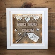 a white framed frame with words and hearts on it that says ournew home