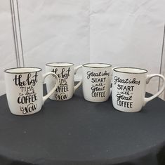 four coffee mugs sitting on top of a table