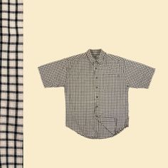 Vintage men's short sleeve top, manufactured ca. 1990s by Natural Stuff. This beige and black window-pane/grid patterned top features a medium thickness cotton fabric, collar, front pocket, and button down closures. Size small.   - Time Period: c. 1990s  - Brand: Natural Stuff  - Size: S  - Colors: Beige, black  - Materials: 100% cotton  - Made in: Nepal  - Condition: In fair to good, vintage condition w/ some minor fabric fraying/loose threads on the bottom left (see close-up with finger pointi Plaid Short Sleeve Camp Shirt With Relaxed Fit, Vintage Style Relaxed Fit Shirt For Everyday, Gingham Cotton Short Sleeve Shirt, Vintage Relaxed Fit Shirt For Everyday, Plaid Short Sleeve Shirt With Relaxed Fit, Gingham Cotton Short Sleeve Tops, Plaid Relaxed Fit Short Sleeve Button-up Shirt, Relaxed Fit Plaid Short Sleeve Button-up Shirt, Classic Short Sleeve Plaid Top