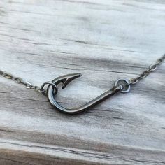 "Really nice looking fish hook necklace! Hook is gunmetal gray and measures 26x16mm. It is on a 16\" gunmetal chain and is attached sideways. Also have this necklace available in other finishes in a longer style that is not sideways." Fishing Necklace, Sterling Silver Jewelry With Fish Hook For Gift, Sterling Silver Fish Hook Earrings, Fishing Hook Necklace, Hunting Jewelry, Fish Hook Jewelry, Afro Jewelry, Western Fashion Jewelry, Fish Hook Necklace