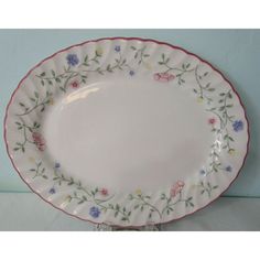 a white and pink plate with flowers on it