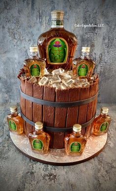 a cake made to look like a barrel with honey bottles on top and an image of a man's face