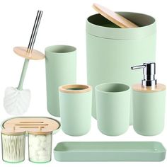 bathroom accessories including soap dispenser, toothbrush holder and other items in mint green