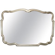 an ornate silver framed mirror on a white background