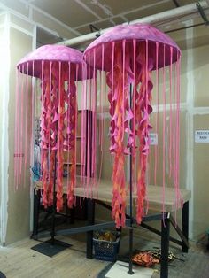 two pink umbrellas are hanging from the ceiling