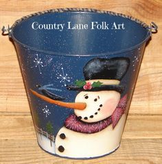 a painted bucket with a snowman on it