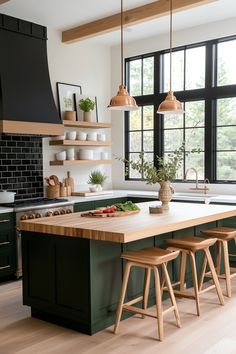 a kitchen with green cabinets and wooden stools