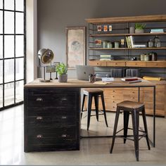 a desk with two stools in front of it and an open bookcase behind it