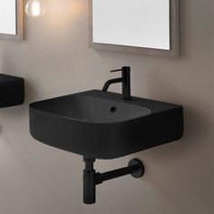 a bathroom sink sitting under two mirrors next to a wall mounted faucet in front of a mirror