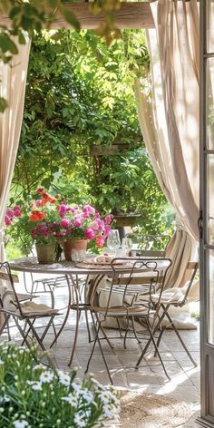 an outdoor dining area with table and chairs