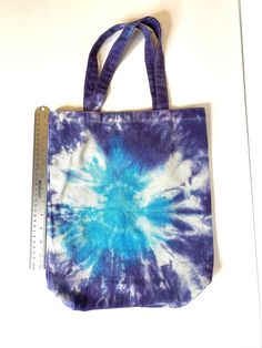 "Tie Dyed One of a Kind Canvas Bag in Bright Blue and Purple! These are 15.5X12.25. The handle is 7.5 inches long and 1\" wide. Fabric Content: 100% Cotton Washing: Can wash in the washer - with like colors." Blue Cotton Tote Shoulder Bag, Large Blue Everyday Bag, Large Blue Bag For Everyday Use, Blue Cotton Bags For Daily Use, Large Blue Canvas Bag, Hand Dyed Rectangular Bags For Daily Use, Everyday Hand Dyed Tote Bag, Everyday Hand Dyed Cotton Bags, Everyday Hand-dyed Tote Bag