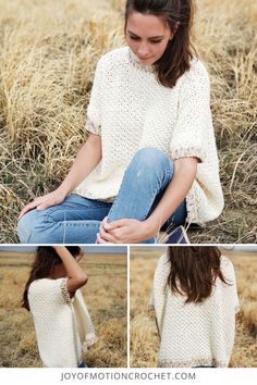 a woman sitting on the ground wearing a white sweater