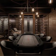 a casino table in the middle of a room with lots of wine glasses on the walls