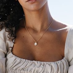 Introducing the Anna Pendant - a stunning, handmade piece of jewelry crafted with gorgeous Mother of Pearl and finished with a delicate gold rolo chain. This unique pendant is sure to be your favorite go-to accessory, adding just the right amount of glimmer and style to any outfit. Don't you deserve to feel luxurious and beautiful? Available in 14k gold plated brass 10mm Mother of Pearl Cabochon 18" rolo chain with 2" extender Lobster claw closure SKU: BYN1375 Pearl Chain Jewelry With Initial Pendant As Gift, Initial Pendant Pearl Chain Jewelry As Gift, Initial Pendant Pearl Chain Jewelry For Gift, Dainty Jewelry With Pearl Charm Initial Pendant, Pearl Chain Necklace With Initial Pendant Gift, Gift Pearl Chain Necklace With Initial Pendant, Elegant Brass Pendant Charm Necklace, Dainty Pearl Pendant Necklace With Initial, Elegant Rose Gold Charm Necklace In Recycled Gold