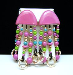 "Cute Vintage Purple, Green, Teal and Black Acrylic Bead Clip On Earrings Gold Tone. Marks - None. Earrings Measure 3 1/2\" Long and 1 3/8\" Wide. Condition is Excellent with No Flaws and Minimal Wear or Aging." Multicolor Beaded Costume Jewelry Earrings, Adjustable Pink Earrings With Large Beads, Pink Large Bead Dangle Earrings, Pink Dangle Earrings With Large Beads, Paint Bar, See You Again Soon, Unique Brooch, Vintage Purple, Black Acrylic