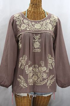 "* Ornate hand embroidery and elegant long sleeves with puff cuffs, available here in FOG with CREAM embroidery. * Light, gauzy and semi-sheer 100% cotton throughout; wear it billowy and flowing in the traditional bohemian style. * Entirely hand dyed, distressed and embroidered for an authentic, retro-vintage and hippie casual vibe. * Our ornate butterfly floral embroidery patterns are a faithful tribute to the original Mexican style hippie blouses of the 1970's. * Caringly embroidered by hand, Cheap Embroidered Semi-stitched Blouse, Cheap Embroidered Hem Blouse For Spring, Luxury Long Sleeve Tunic With Floral Embroidery, Cheap Long Sleeve Peasant Top With Floral Print, Luxury Bohemian Long Sleeve Embroidered Top, Luxury Bohemian Blouse Piece For Festive Season, Affordable Long Sleeve Peasant Top For Vacation, Cheap Spring Blouse With Embroidered Neckline, Cheap Floral Embroidered 3/4 Sleeve Blouse