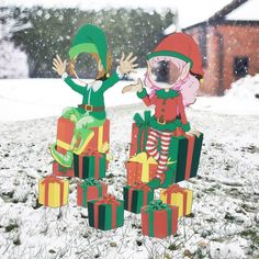 two elfs are standing in the snow with presents