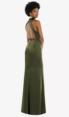 a woman in a long green dress with an open back and cutout at the neck