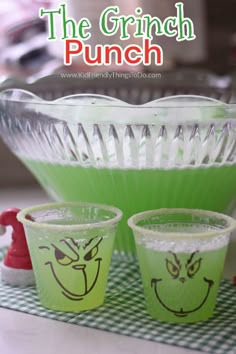 the grinch punch cups are ready to be filled with green jello and sprinkles