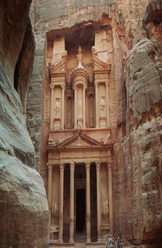 an ancient building built into the side of a cliff