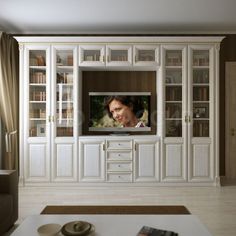 a large white entertainment center in a living room