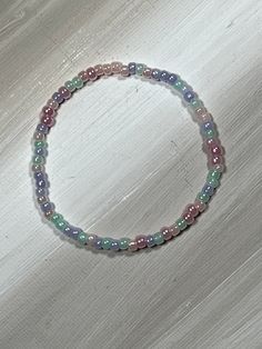 Pastel bead bracelet, perfect for older children and teens. stretch bracelet has pink, green, lavender and iridescent beads on clear elastic. perfect for spring and Easter, a great gift for older kids and teens. bracelet is available in several sizes. comes ready to gift with organza bag and gift card.   Mix and match multiple colors to wear together! Colors To Wear Together, Bracelet For Kids, Pastel Beads, Green Lavender, Spring Bracelet, Kids Easter, Organza Bags, Bead Bracelet, Stretch Bracelet