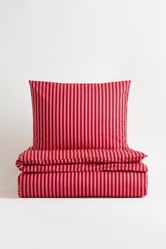 red and white striped bedding set with matching pillowcases on the bottom side