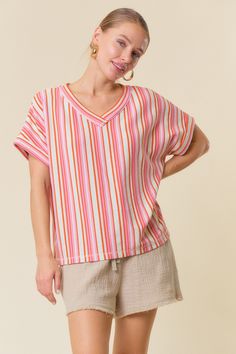 Details Brand: Doe and Rae Oversized Top Multi Colored Striped Pattern Textured Fabric V Neckline Rolled Short Sleeves Boxy Cut Material 61% Polyester 37% Cotton 2% Spandex Measurements of Garment Bust of the garment is measured armpit to armpit and then doubled. Length of the garment is measured from the top of the shoulder to the bottom of the hem line. Sleeve Length of the garment is measured from the top part of the shoulder seam to sleeve opening. Waist of the garment is measured straight a Oversized Striped Beach Top, Oversized Striped Tops For Vacation, Oversized Pink V-neck Top, Oversized Multicolor Beach Top, Oversized Multicolor Tops For Beach, Casual Multicolor Loungewear Blouse, Multicolor V-neck Loungewear Top, Striped Oversized Top For Day Out, Multicolor V-neck Tops For Loungewear