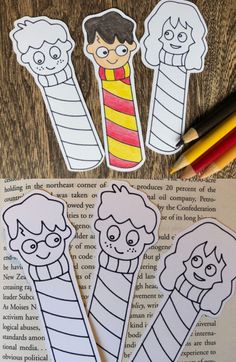 two children's bookmarks with pencils and paper cutouts on top of them