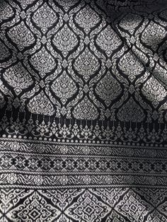 an intricate black and white pattern on fabric