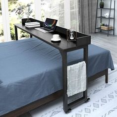 a bed with a laptop on top of it