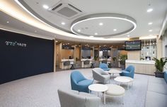 an office with blue chairs and white tables