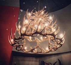 a deer antler chandelier hanging from the ceiling