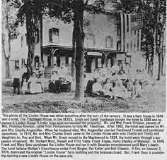 an old black and white photo of people in front of a house