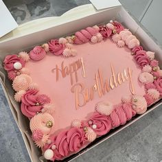 a pink birthday cake in a box with the words happy birthday written on it's side