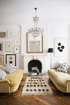 a living room with two couches and a coffee table in front of a fireplace