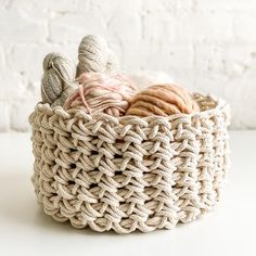 two balls of yarn in a woven basket