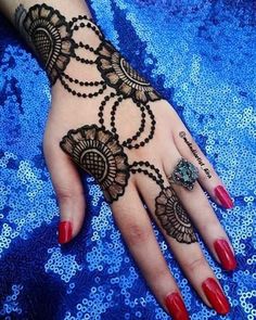 a woman's hand with henna tattoos on it